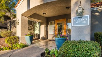 Estancia leasing office entrance with nice well trimmed greens